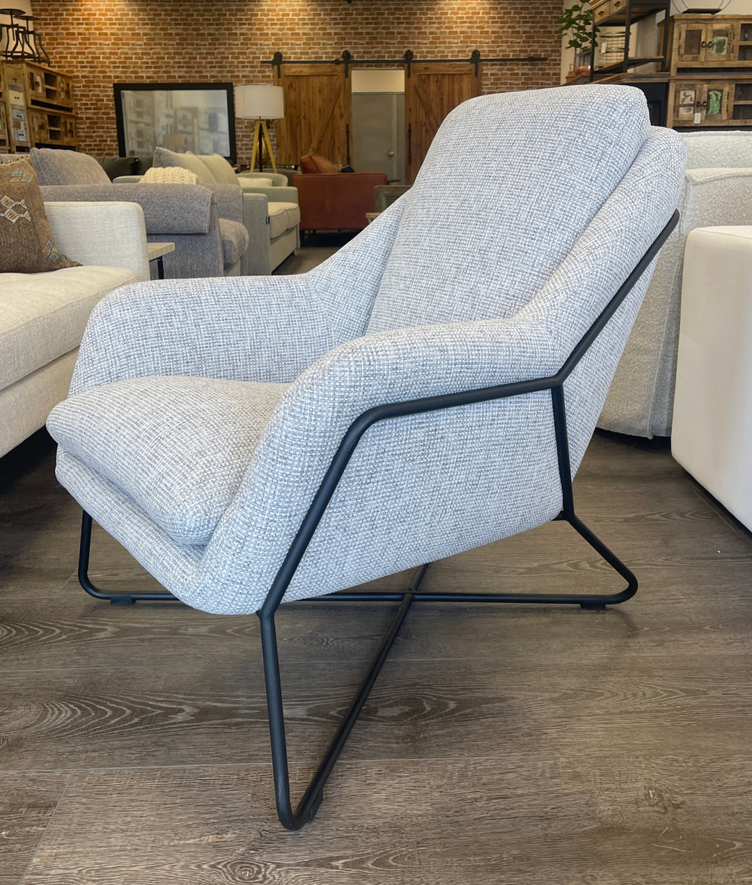 Combined mid-century modern styling and grey tweed upholstery push this Monroe club chair to the top of current furnishing trends.