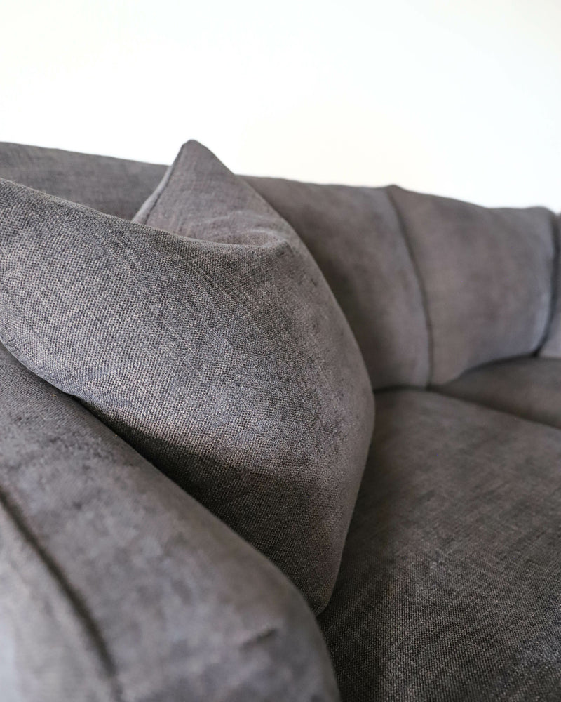 close up shot of dark grey deep seat sofa