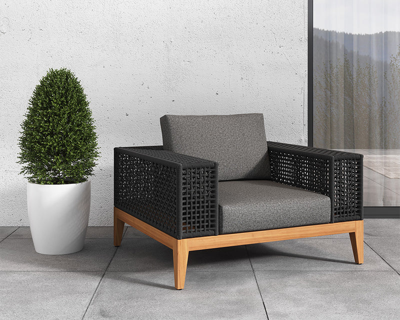 Features a deep seat in gracebay grey fabric with wide powder coated aluminum armrests wrapped in dark greymix weave. A solid natural teak wood frame completes the design.